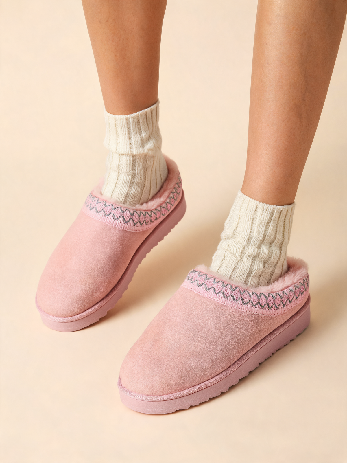 Pink women's slippers close-up of braided trim