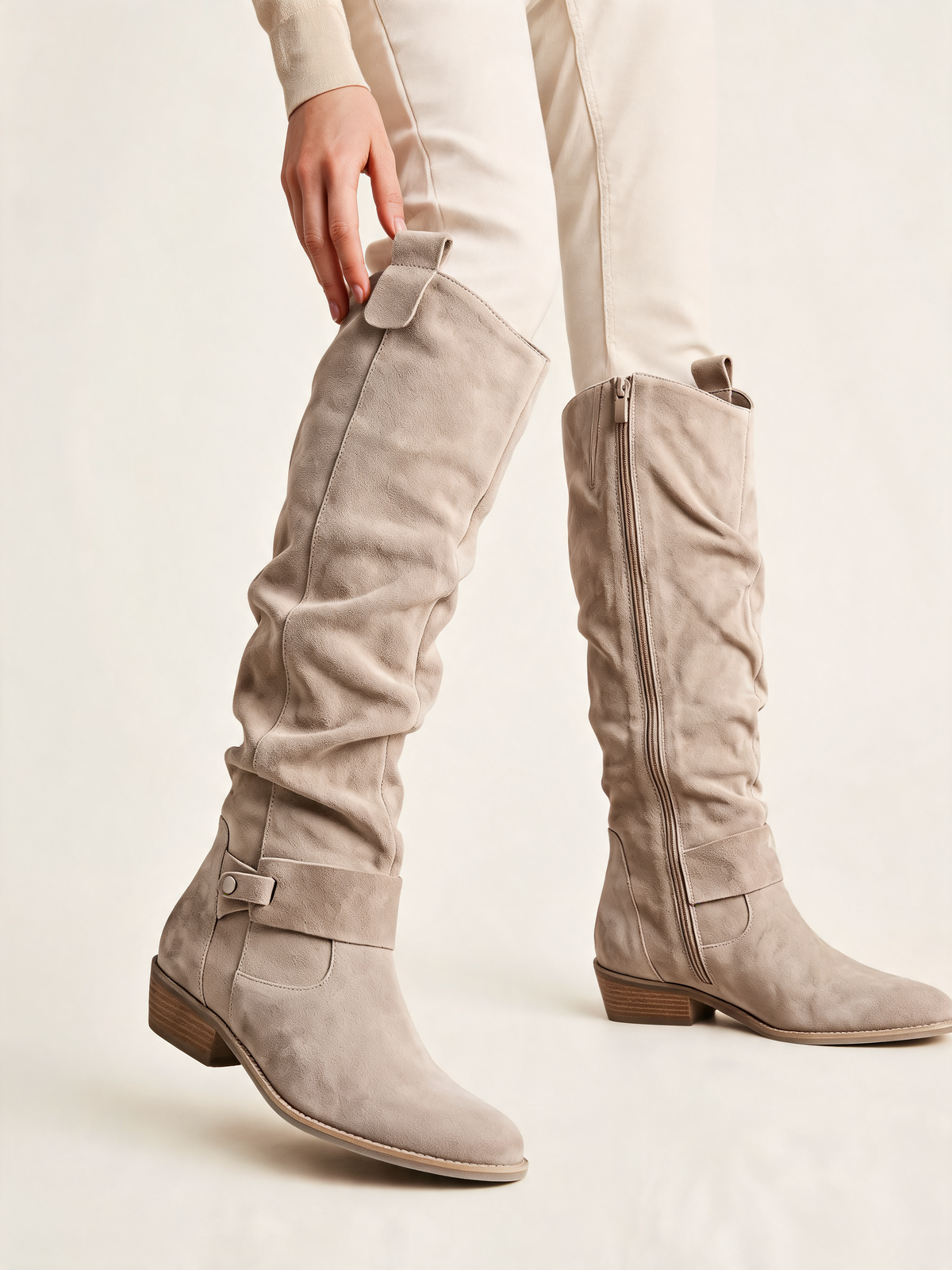 Beige slouch knee high boots – close-up of buckle strap and side zip