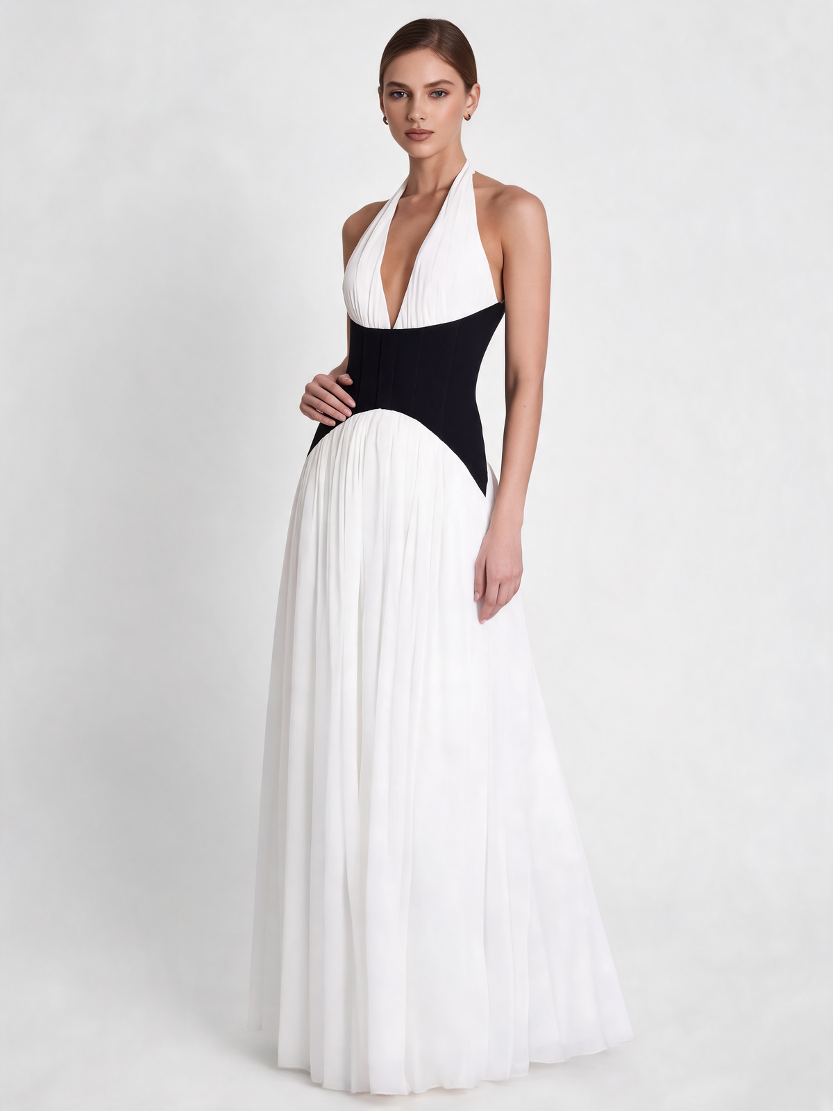White halterneck party dress with black waist, three-quarter view
