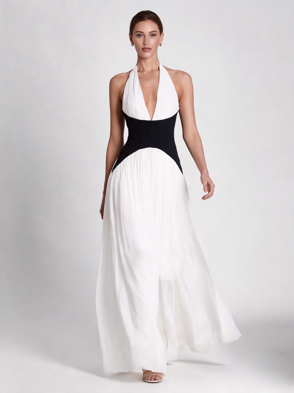 White halterneck party dress with black waist, walking view