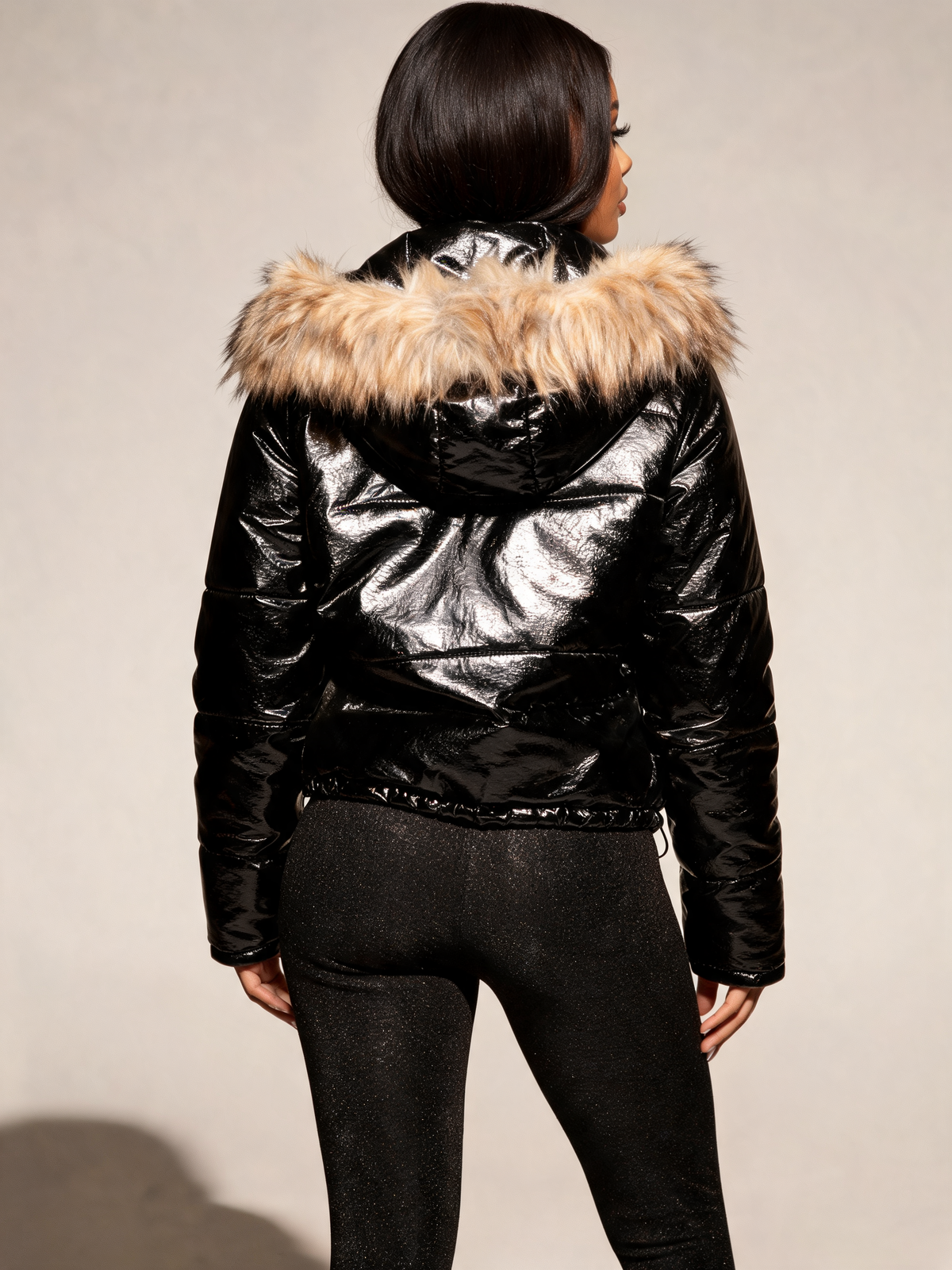 Black puffer jacket women back view